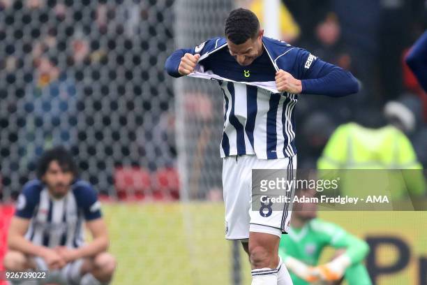 Jake Livermore of West Bromwich Albion reacts as he rips his shirt in frustration after West Bromwich Albion concede a goal to make it 1-0 during the...