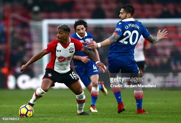 Mario Lemina of Southampton runs with the ball away from the pressure of Geoff Cameron of Stoke City during the Premier League match between...