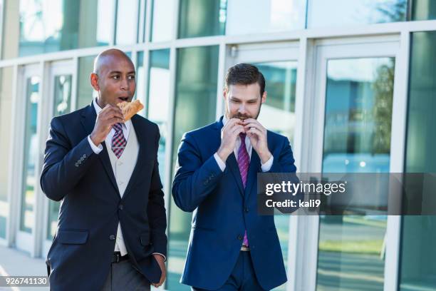 businessmen eating lunch on the go - business lunch outside stock pictures, royalty-free photos & images