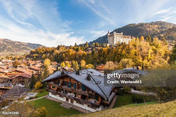 switzerland, canton of bern, gstaad, townscape with gstaad palace hotel - gstaad stock pictures, royalty-free photos & images