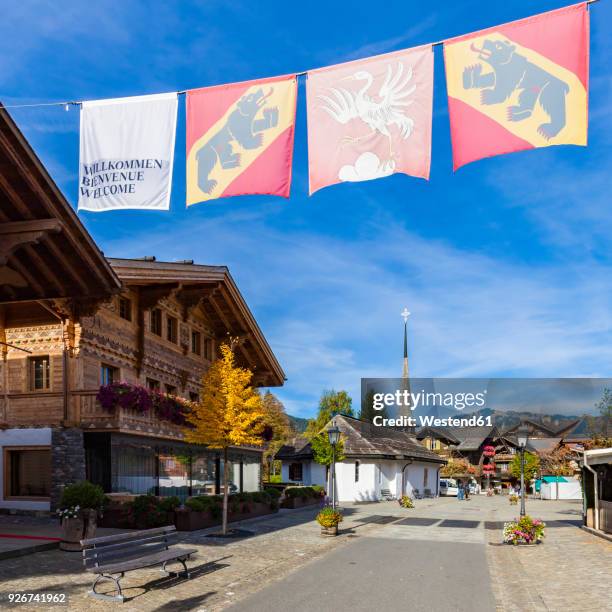 switzerland, canton of bern, gstaad, pedestrian area and chapel - gstaad stockfoto's en -beelden