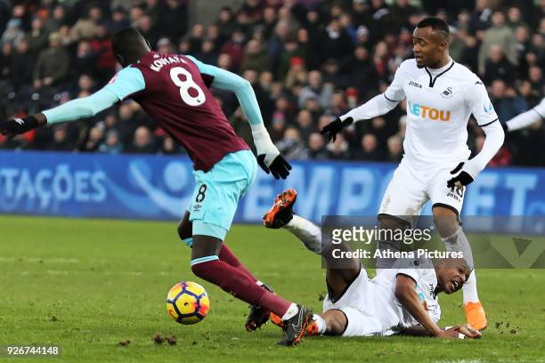Andre Ayew of Swansea City is brought down by Cheikhou Kouyate of West Ham for which referee Martin Atkinson gave a penalty during the Premier League...