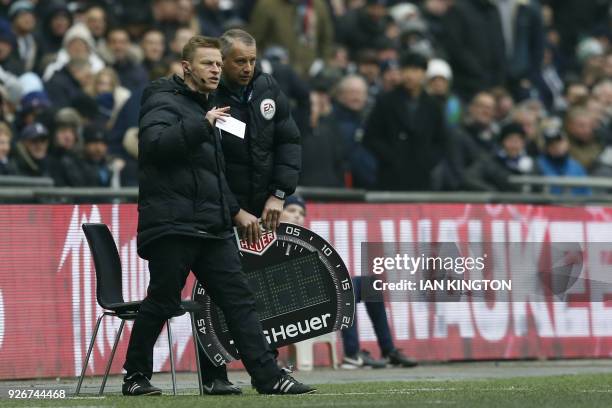 Injured referee Michael Jones is on the side lines during the English Premier League football match between Tottenham Hotspur and Huddersfield at...