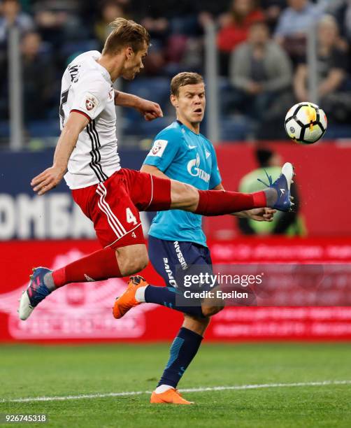 Aleksandr Kokorin of FC Zenit Saint Petersburg and Nikolai Zaytsev of FC Amkar Perm vie for the ball during the Russian Football League match between...