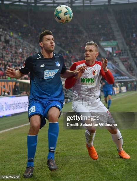 Adam Szalai of Hoffenheim and Philipp Max of Augsburg compete for the ball during the Bundesliga match between FC Augsburg and TSG 1899 Hoffenheim at...