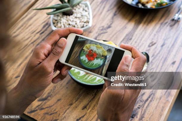 male hands taking a picture of smoothie bowl with smartphone - indonesia photos 個照片及圖片檔