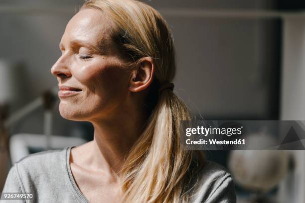 portrait of smiling woman's face in sunlight - eyes closed bildbanksfoton och bilder