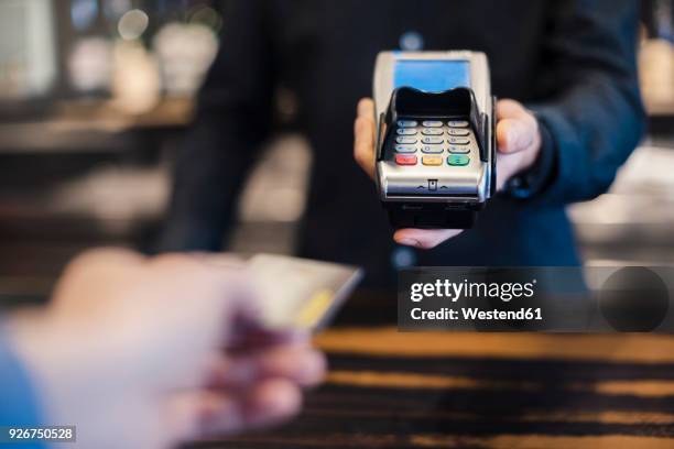 man using credit card reader, close-up - credit card reader stock pictures, royalty-free photos & images