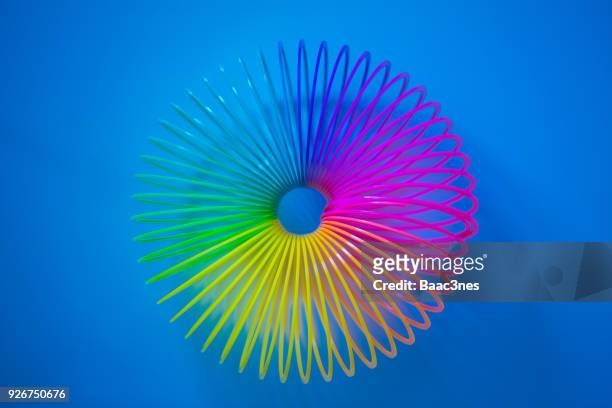 colorful slinky toy bent like a circle - metal coil stock pictures, royalty-free photos & images