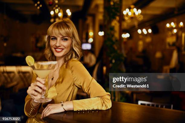 portrait of elegant woman with cocktail in a bar - cocktail dress bildbanksfoton och bilder