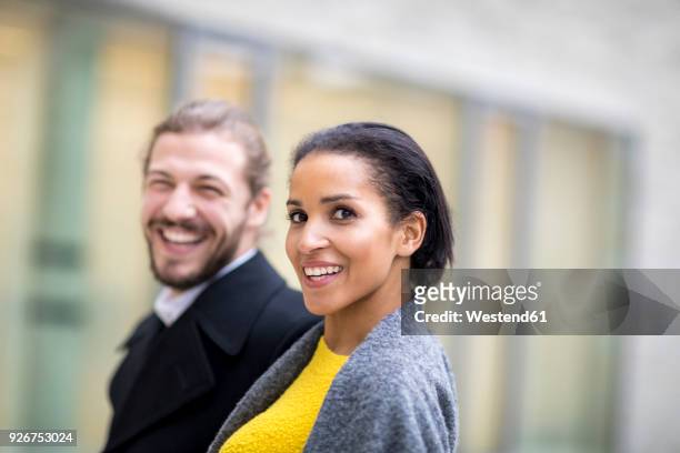portrait of laughing young woman with her partner in the background - ambient light stock pictures, royalty-free photos & images