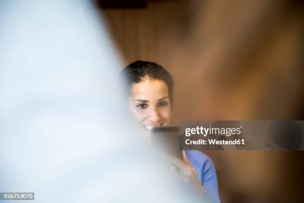 portrait of laughing woman taking photo with cell phone - ambient light stock pictures, royalty-free photos & images