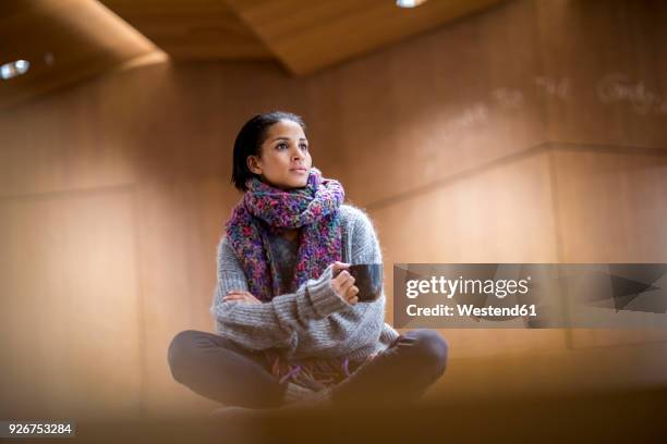 portrait of fashionable young woman with cup of coffee - ambient light stock pictures, royalty-free photos & images