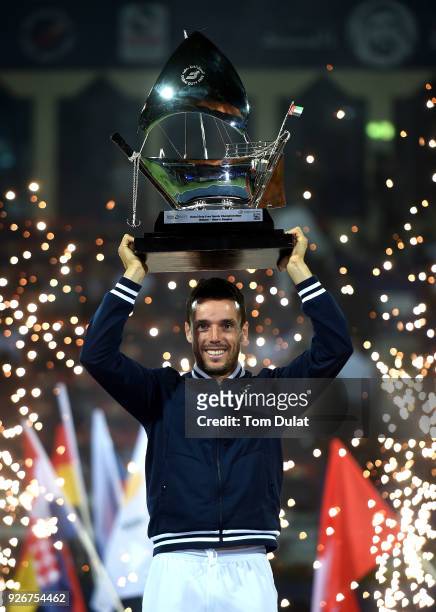 Roberto Bautista Agut of Spain poses with the trophy after winning the final match against Lucas Pouille of France on day six of the ATP Dubai Duty...