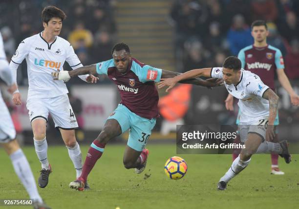 Michail Antonio of West Ham United in action with Kyle Naughton of Swansea City during the Premier League match between Swansea City and West Ham...
