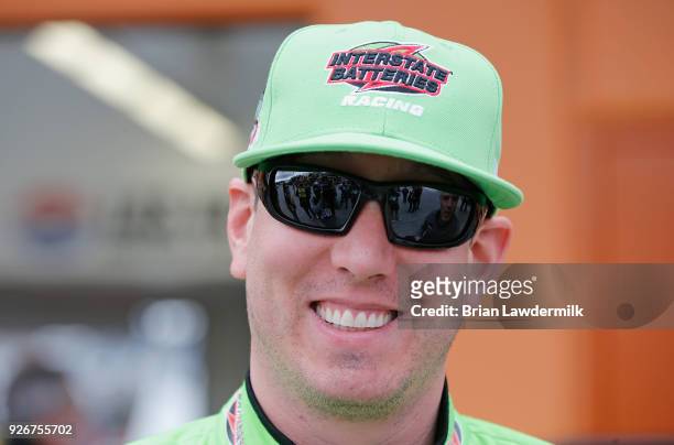 Kyle Busch, driver of the M&M's Caramel Toyota, stands in the garage during practice for the Monster Energy NASCAR Cup Series Pennzoil 400 presented...