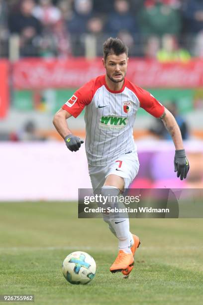 Marcel Heller of Augsburg plays the ball during the Bundesliga match between FC Augsburg and TSG 1899 Hoffenheim at WWK-Arena on March 3, 2018 in...