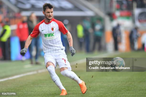 Marcel Heller of Augsburg plays the ball during the Bundesliga match between FC Augsburg and TSG 1899 Hoffenheim at WWK-Arena on March 3, 2018 in...
