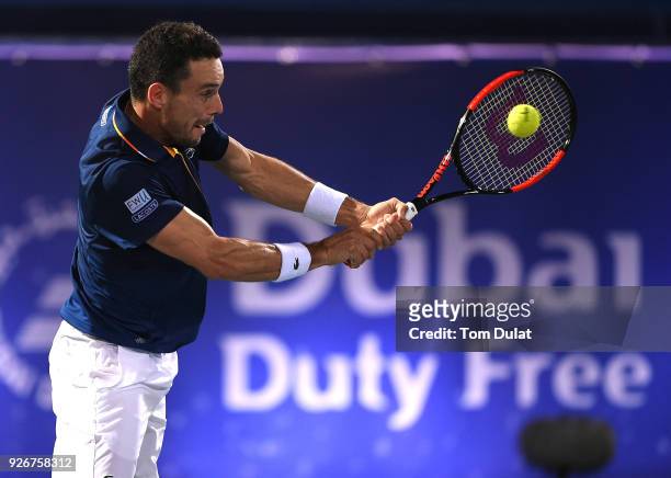 Roberto Bautista Agut of Spain plays a backhand during his final match against Lucas Pouille of France on day six of the ATP Dubai Duty Free Tennis...