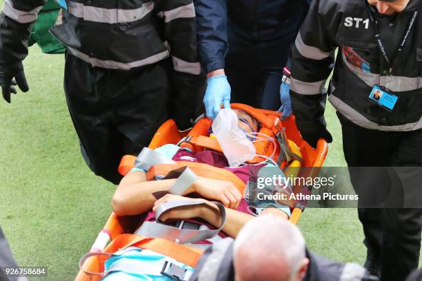 Winston Reid of West Ham is being carried away on a stretcher during the Premier League match between Swansea City and West Ham United at The Liberty...