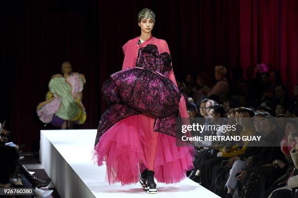 Model presents a creation for Comme des Garcons during the 2018/2019 fall/winter collection fashion show on March 3, 2018 in Paris. / AFP PHOTO /...