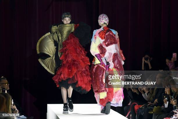 Model presents a creation for Comme des Garcons during the 2018/2019 fall/winter collection fashion show on March 3, 2018 in Paris.