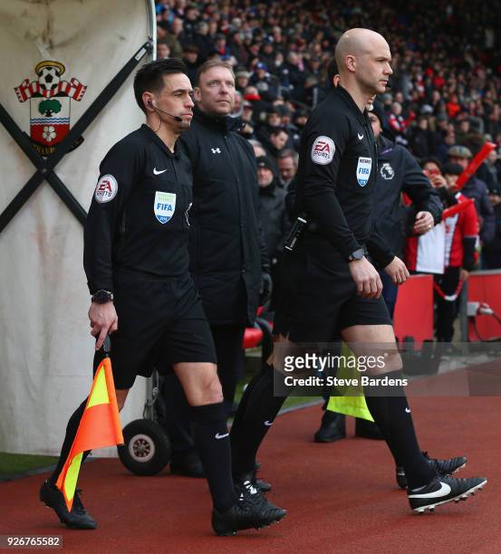 Referee Anthony Taylor and assistant referee Adam Nunn lead the teams out prior the Premier League match between Southampton and Stoke City at St...