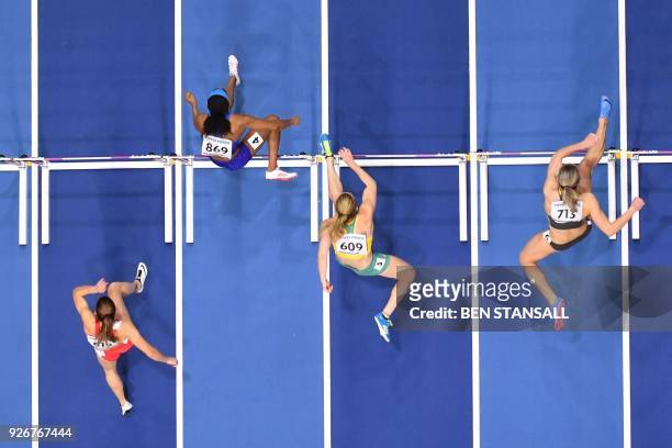 Belarus' Alina Talai, US athlete Kendra Harrison, Australia's Sally Pearson, Germany's Cindy Roleder compete in the women's 60m hurdles semi-finals...