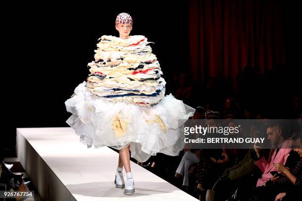 Model presents a creation for Comme des Garcons during the 2018/2019 fall/winter collection fashion show on March 3, 2018 in Paris. / AFP PHOTO /...