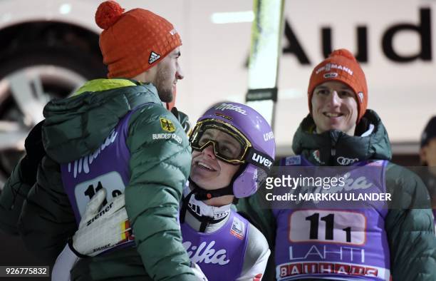Germany's Markus Eisenbichler, Andreas Wellinger, Karl Geiger and Richard Freitag react after the ski jumping team competition HS130 of the FIS World...