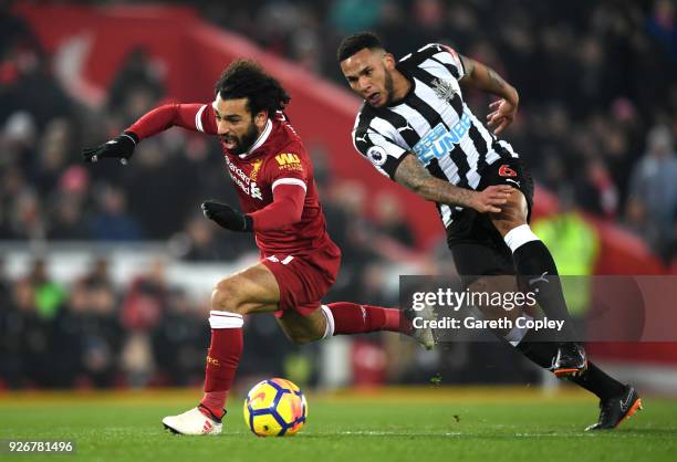 Mohamed Salah of Liverpool clashes with Jamaal Lascelles of Newcastle United during the Premier League match between Liverpool and Newcastle United...