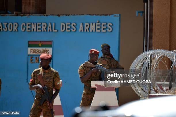 Burkinabe soldiers patrol the army's headquarters in Ouagadougou on March 3, 2018 a day after dozens of people were killed in twin attacks on the...