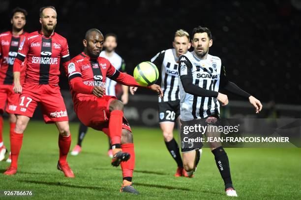 Guingamp's Franch-Congolese defender Jordan Ikoko vies with Angers' French midfielder Thomas Mangani during the French Ligue 1 football match between...