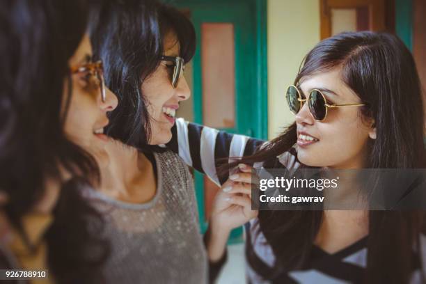 group of female friends gossiping together. - indian woman short hair stock pictures, royalty-free photos & images