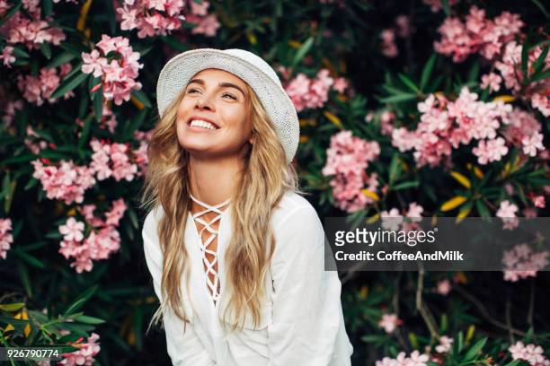 beautiful girl on the background of spring bush - summer frock stock pictures, royalty-free photos & images