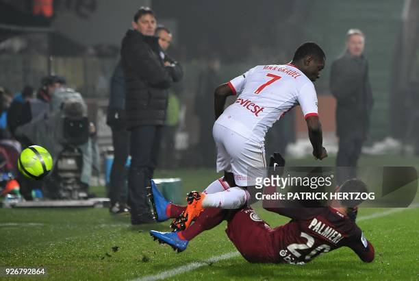 Metz's French defender Julian Palmieri tackles Toulouse's Ivory Coast forward Max Gardel prior to receive a red card, during the French L1 football...