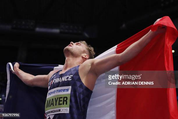 France's Kevin Mayer reacts after taking gold in the men's heptathlon event at the 2018 IAAF World Indoor Athletics Championships at the Arena in...