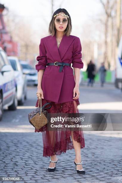 Aimee Song poses with a Louis Vuitton bag after the Elie Saab show at the Grand Palais during Paris Fashion week Womenswear FW 18/19 on March 3, 2018...