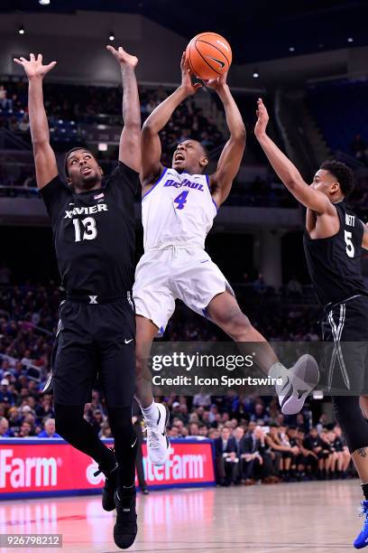 DePaul Blue Demons's Brandon Cyrus is fouled shoots against Xavier Musketeers forward Naji Marshall and Xavier Musketeers guard Trevon Bluiett during...