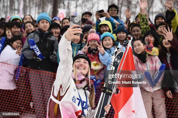 Justine Dufour-Lapointe of Canada takes a 'selfie' with the crowd during day one of the FIS Freestyle Skiing World Cup Tazawako at Tazawako Ski...