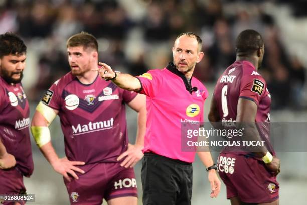 French referre Romain Poite gestures during the French Top 14 rugby union match between Bordeaux-Begles and Toulouse on March 3, 2018 at the...
