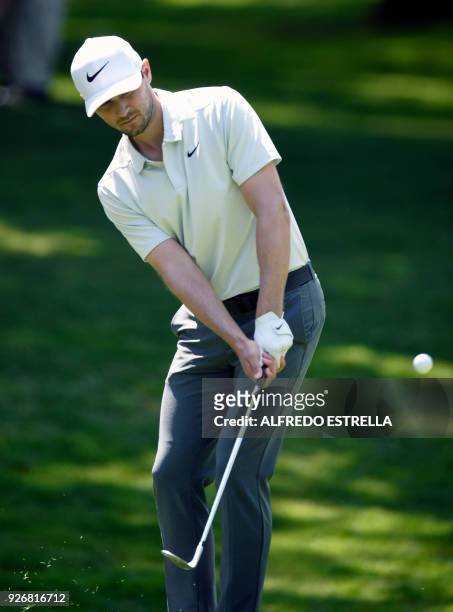 Golfer Kyle Stanley, plays his shot at green one, during the third round of the World Golf Championship in Mexico City, on March 3, 2018. / AFP PHOTO...