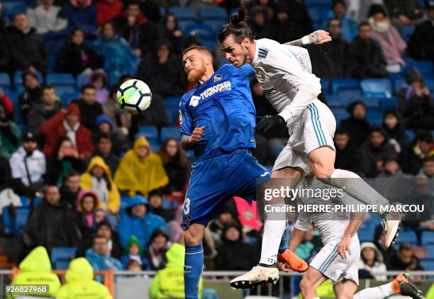 Getafe's Portuguese defender Vitorino Antunes vies with Real Madrid's Welsh forward Gareth Bale during the Spanish league football match Real Madrid...