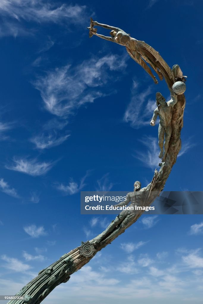 The Millennia sculpture of evolutionary and human history against a blue sky on the Malecon Puerto Vallarta