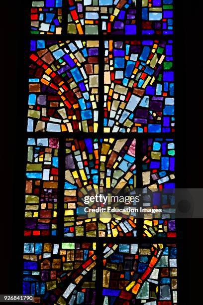 Abstract multicolor sun pattern of a stained glass window mosaic in a Toronto Roman Catholic church.