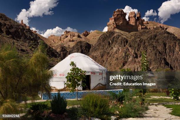 Yurt accommodation at Eco Park in Charyn Canyon National Park with red sandstone hoodoos Kazakhstan.