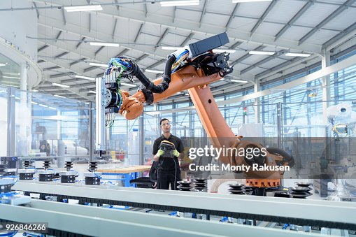 Engineer programming robot in robotics research facility Engineer programming robot in robotics research facility