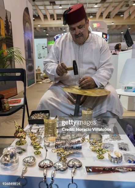 Craftsman works on jewelry at Morocco stand in BTL "Bolsa de Turismo Lisboa" trade fair on March 03, 2018 in Lisbon, Portugal. BTL is the benchmark...