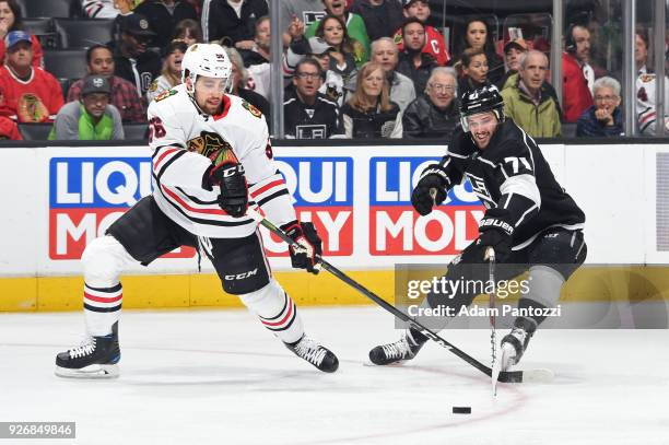 Erik Gustafsson of the Chicago Blackhawks battles for the puck against Torrey Mitchell of the Los Angeles Kings at STAPLES Center on March 3, 2018 in...