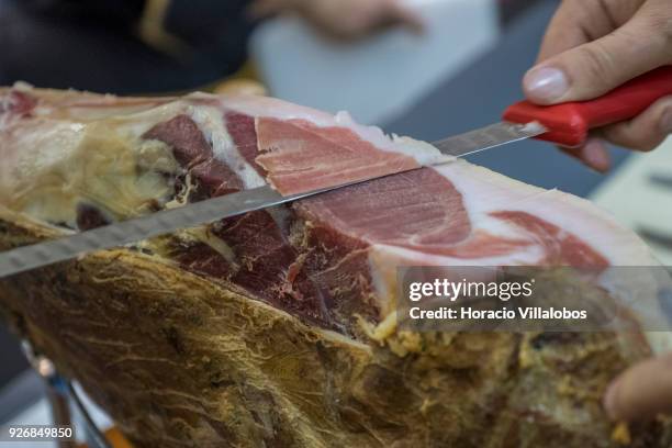 Portuguese Chef Vitor de Oliveira slices into a smoked ham at Porto-Norte stand as part of the presentation of the touristic "Rota do Presunto...